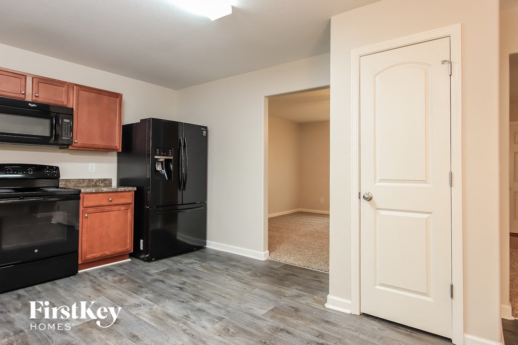 a kitchen with black appliances and wooden cabinets