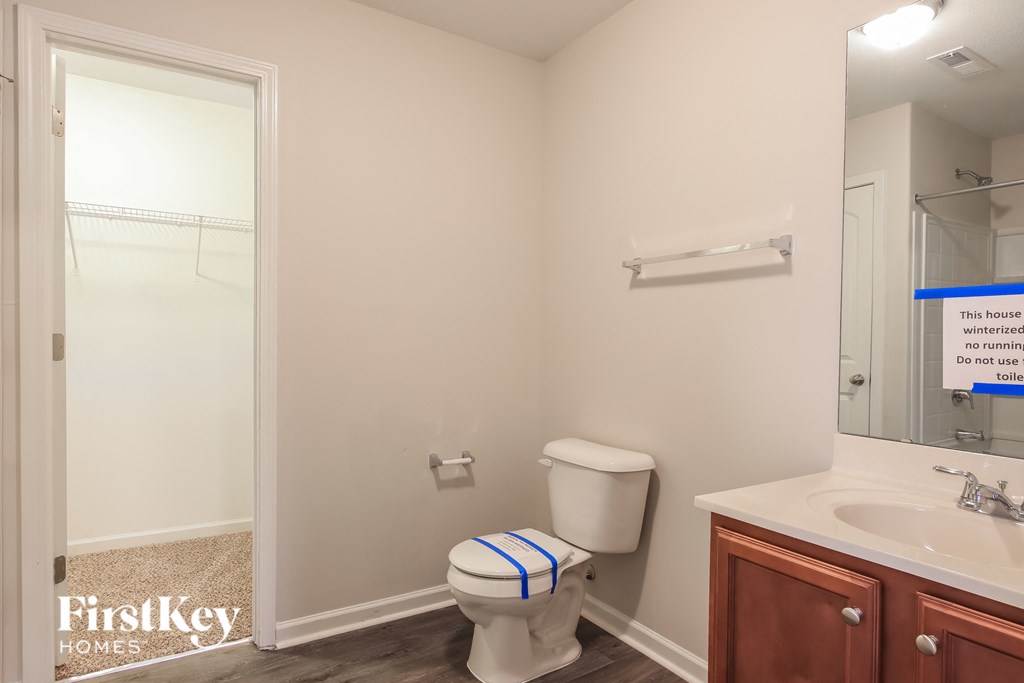 a bathroom with a toilet and a sink and a shower