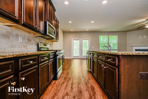 A kitchen with wooden cabinets and a tile backsplash.