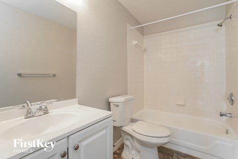 a bathroom with a sink toilet and bath tub