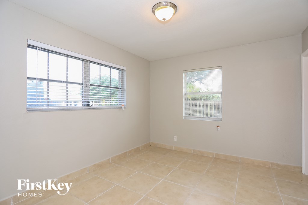 A room with a FirstKey Homes logo on the bottom left corner.