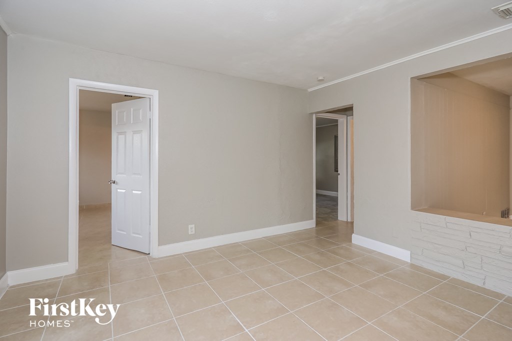 A room with a white door and a window with a white frame.