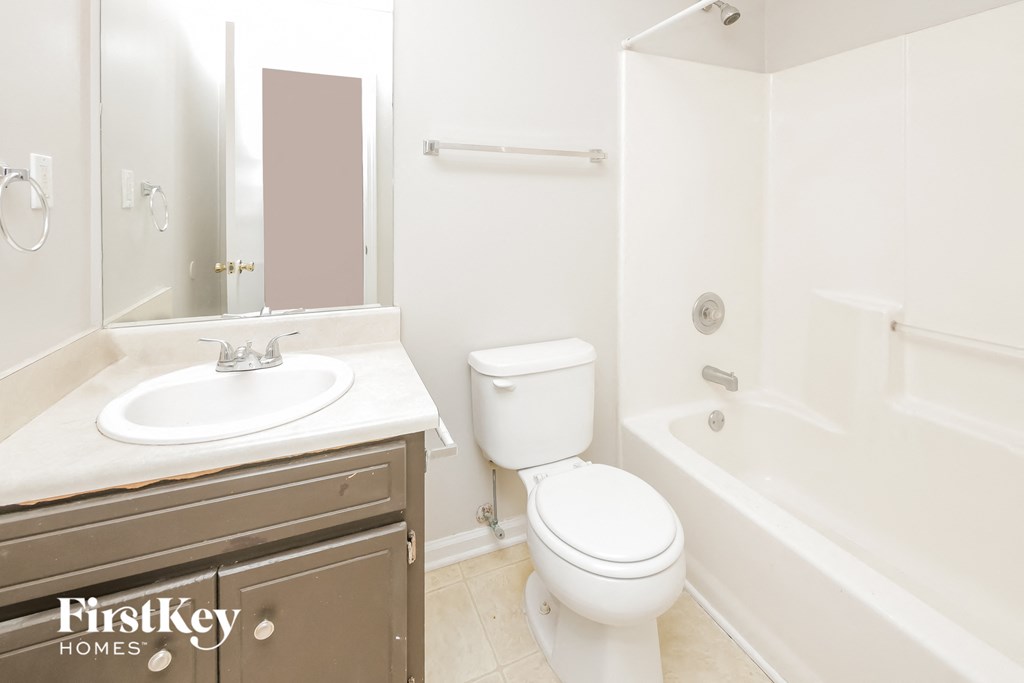 a bathroom with a sink toilet and a bath tub