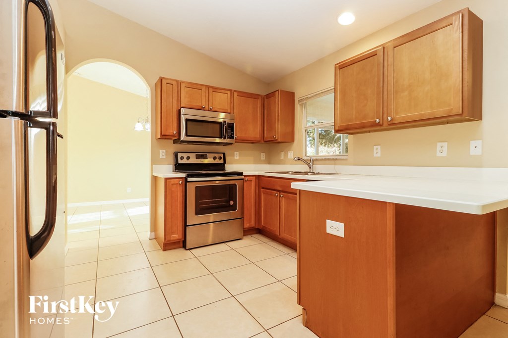 a kitchen with wooden cabinets and stainless steel appliances