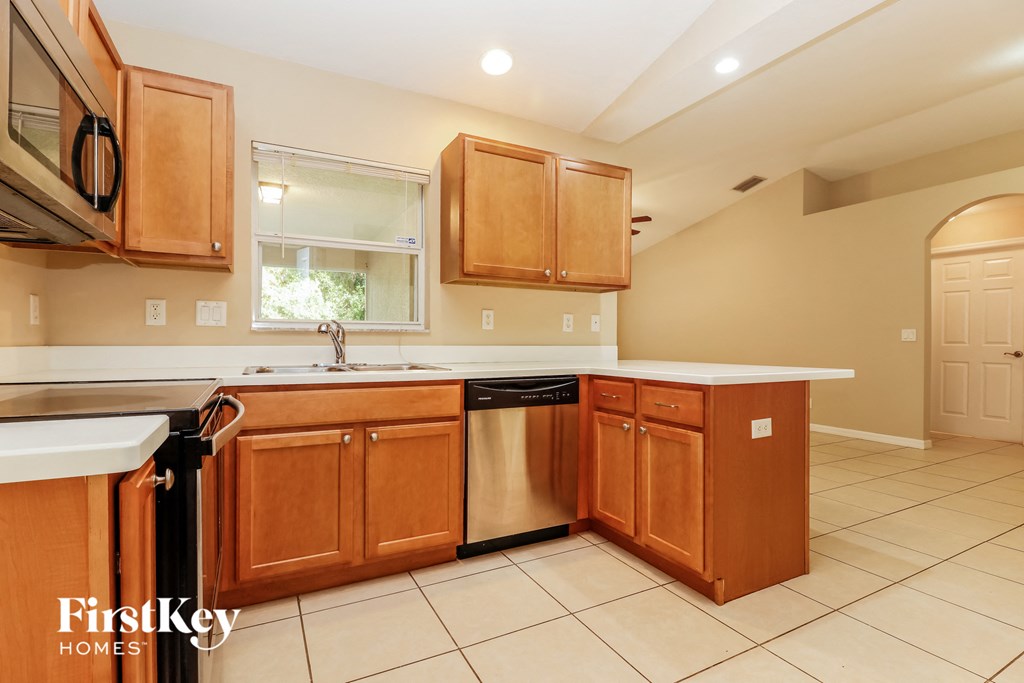 a kitchen with wooden cabinets and a dishwasher and a sink
