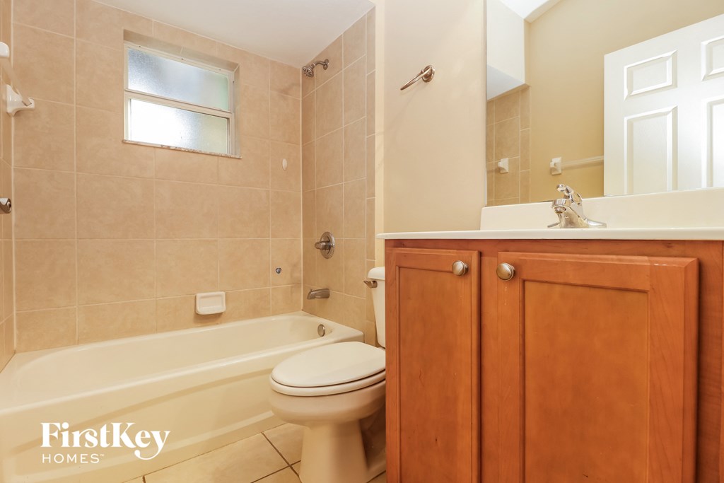 a bathroom with a toilet and a sink and a bath tub