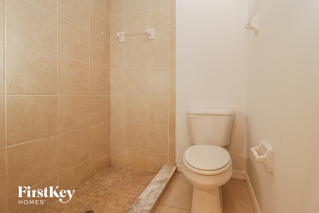 a small bathroom with a toilet and a shower