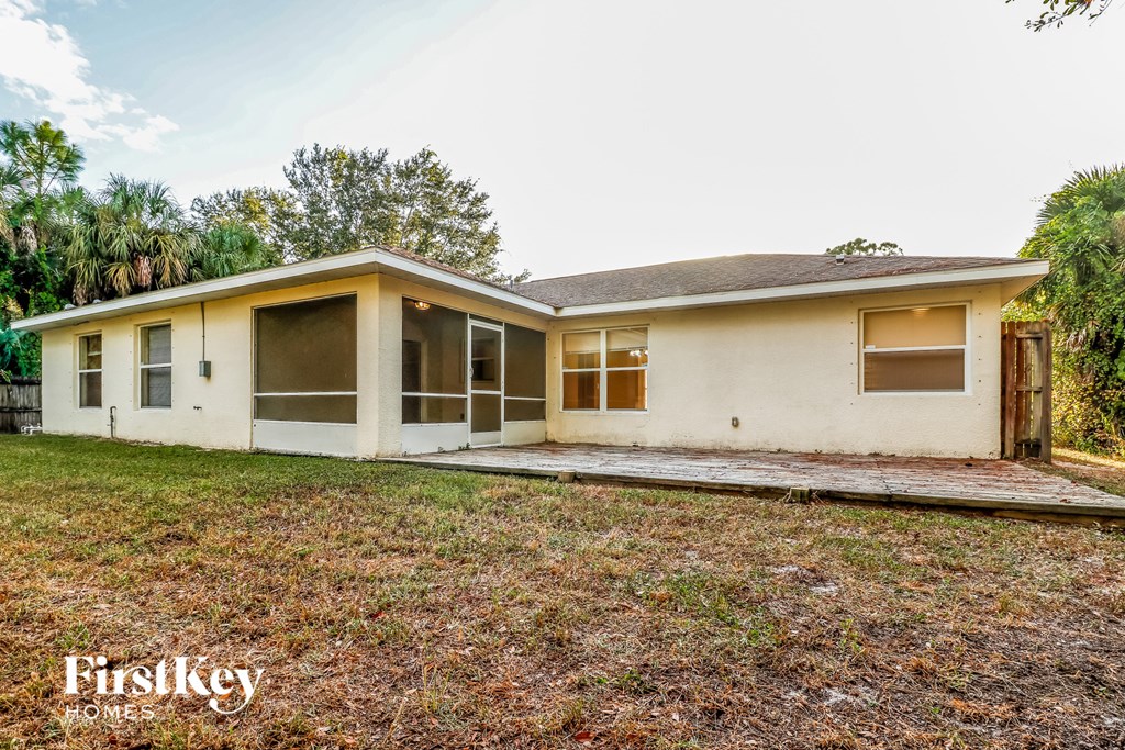 a small white house with a yard and a porch