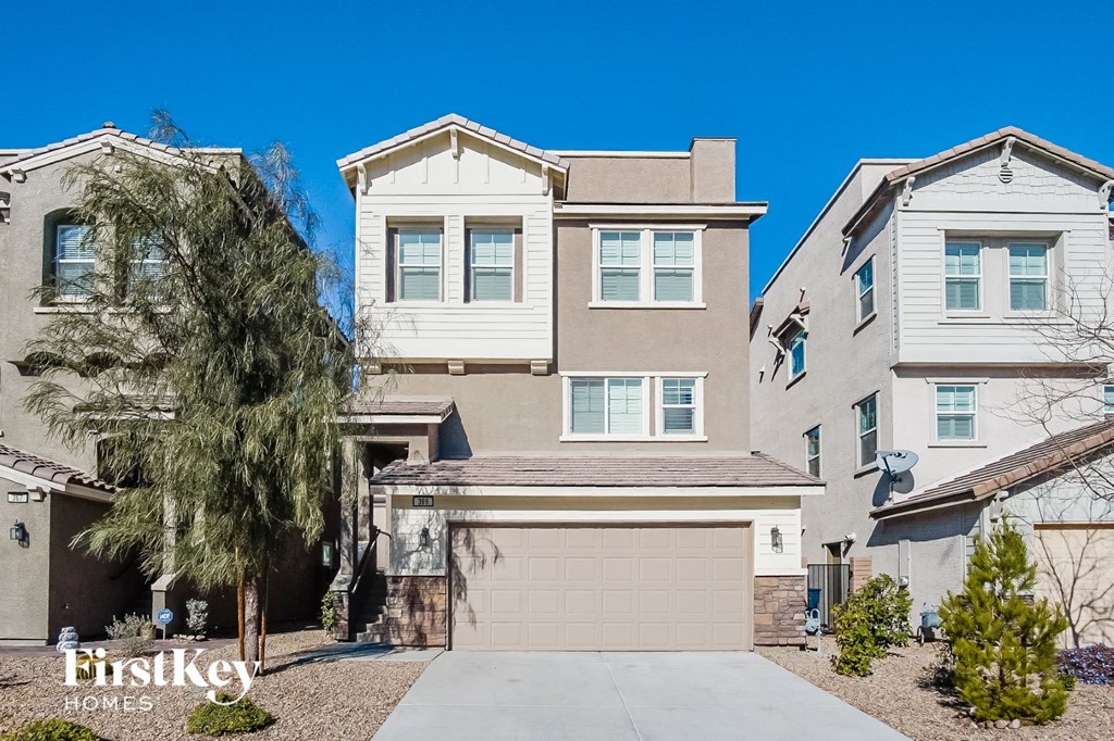a beige and tan house with a garage door