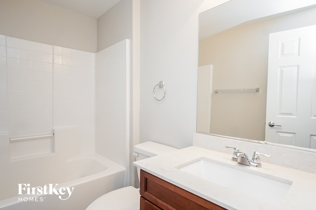 a bathroom with a sink and a toilet and a bath tub