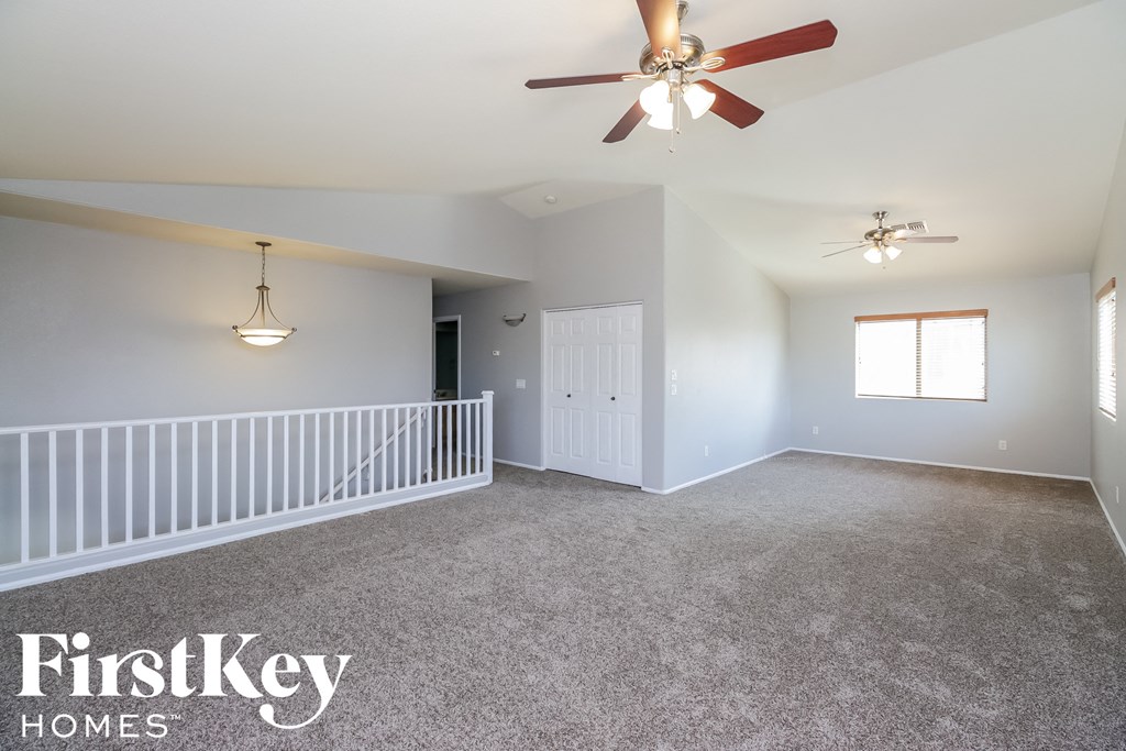 a nursery with a crib and a ceiling fan