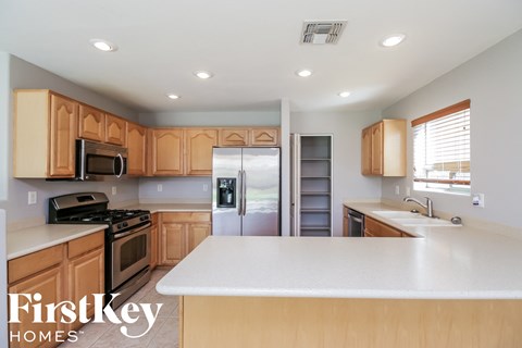 a kitchen with wooden cabinets and a white counter top