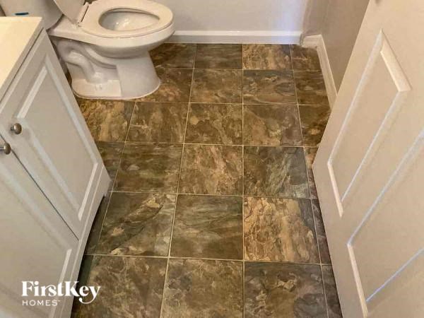 a bathroom with a toilet and a white door