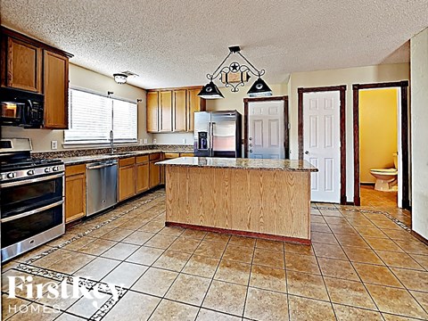 a kitchen with a large island in the middle of it