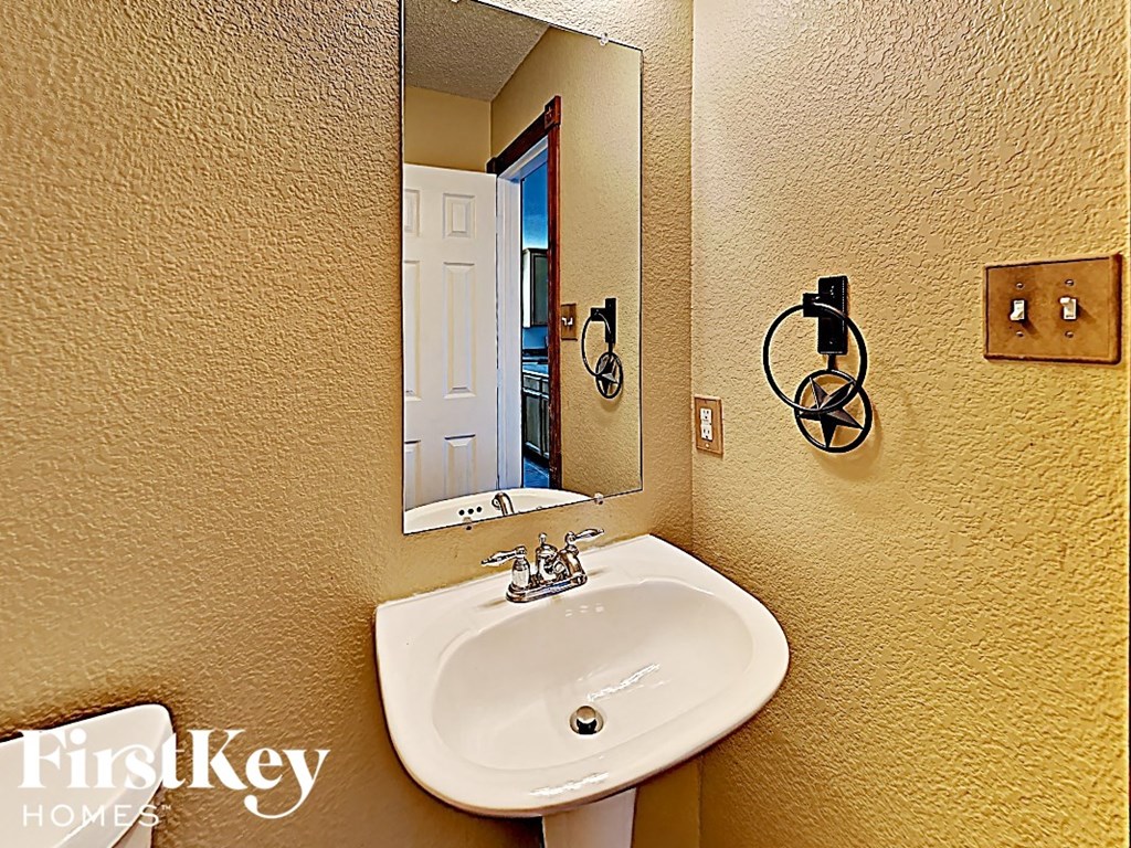 a bathroom with a white sink and a mirror