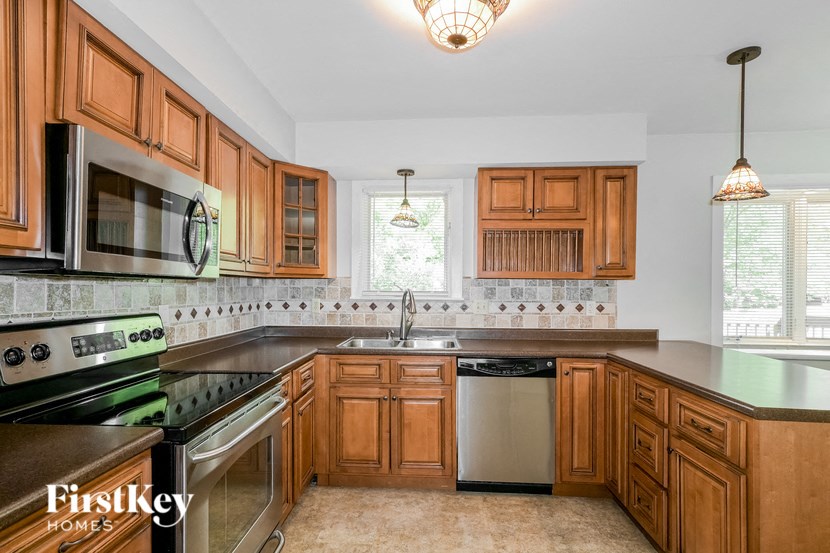 a kitchen with wooden cabinets and stainless steel appliances