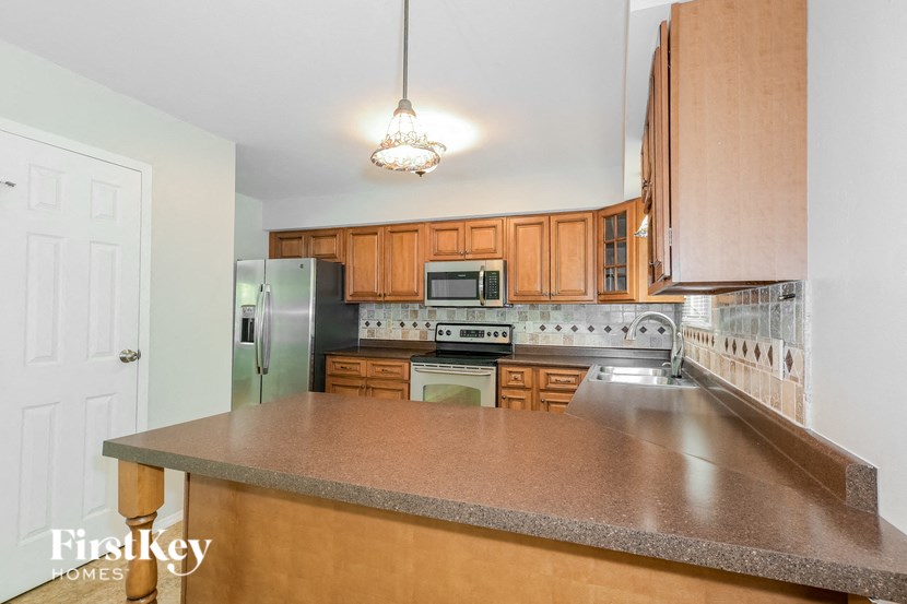 a kitchen with wooden cabinets and a counter top