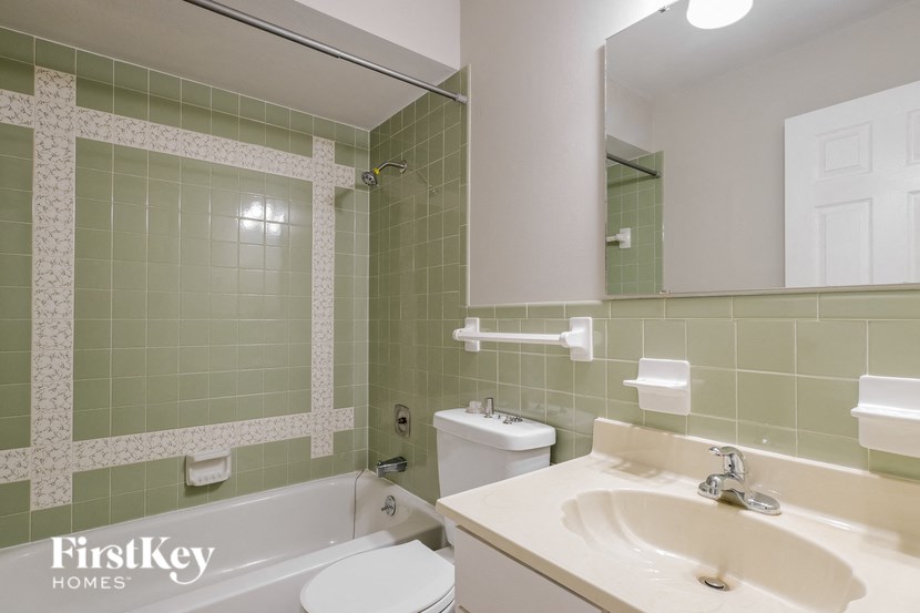 a bathroom with a sink toilet and a bath tub