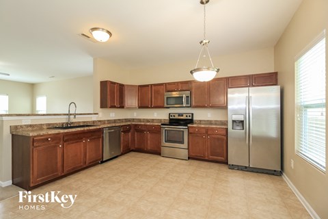 A kitchen with wooden cabinets and stainless steel appliances.