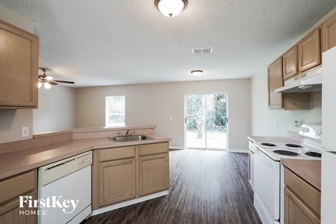 A kitchen with wooden cabinets and white appliances.