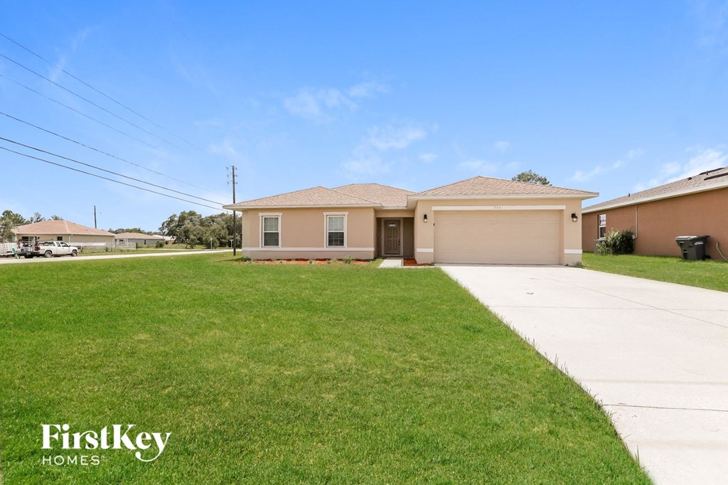 A house with a lawn in front of it and the words "FirstKey Homes" on the bottom left.