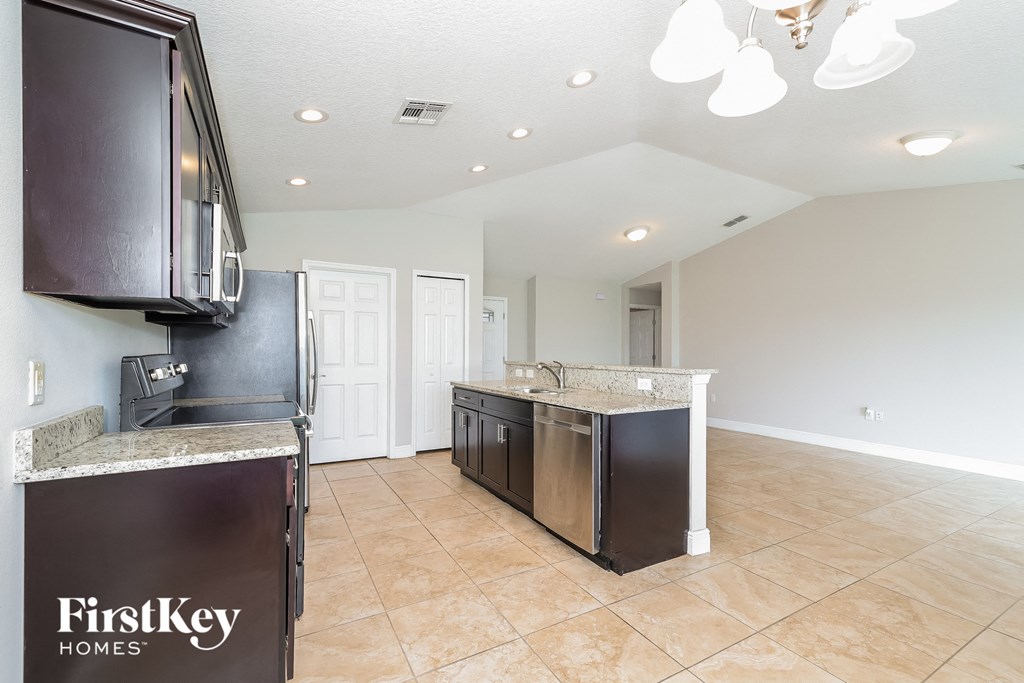 A kitchen with a FirstKey Homes sign on the island.