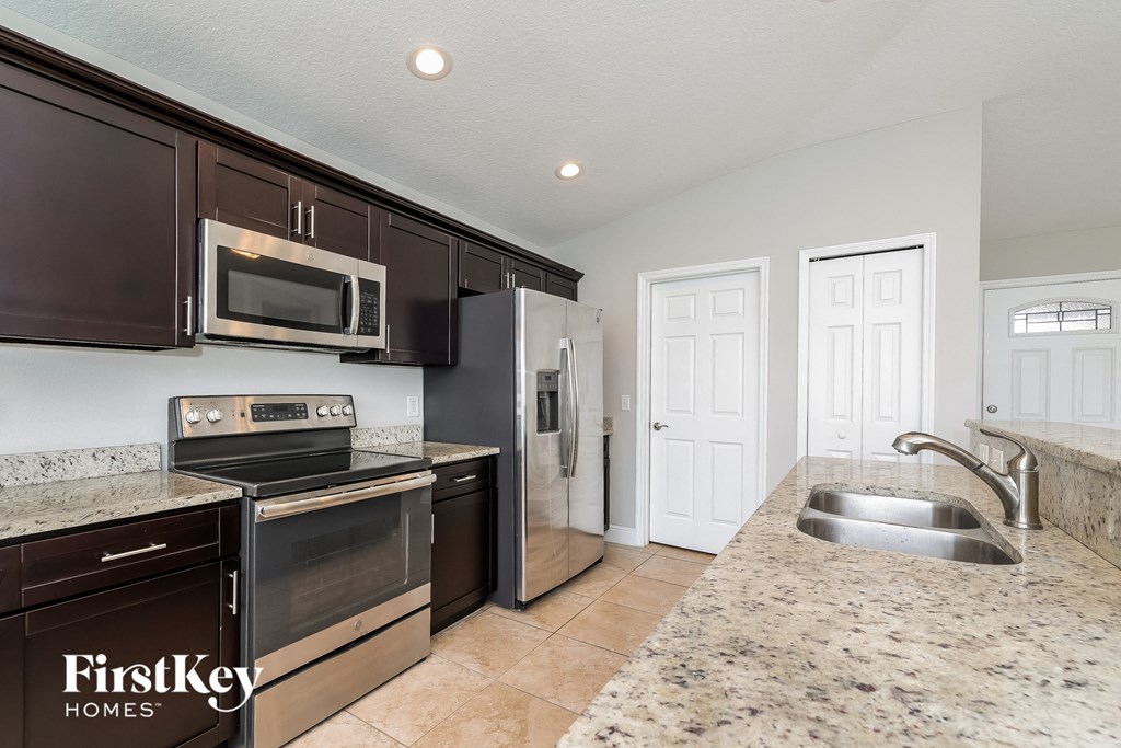 A kitchen with a granite countertop and a sink.