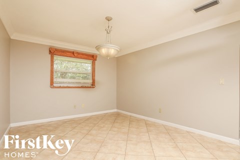A room with a window and a light fixture.