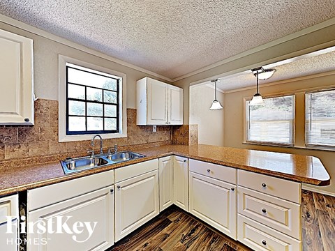 A kitchen with a sink and a window.