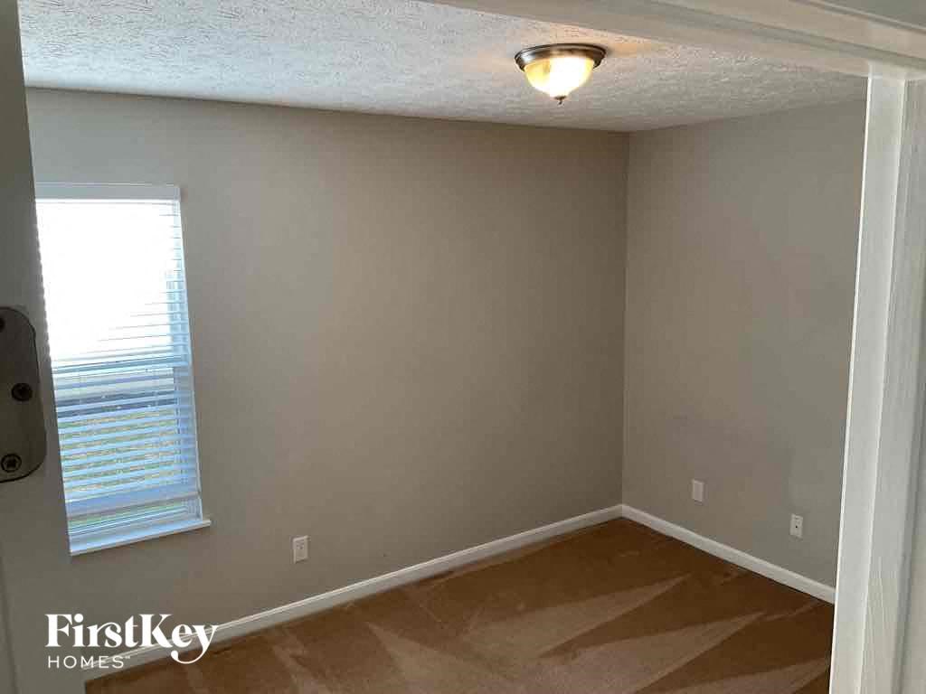 A room with a window and a light on the ceiling.