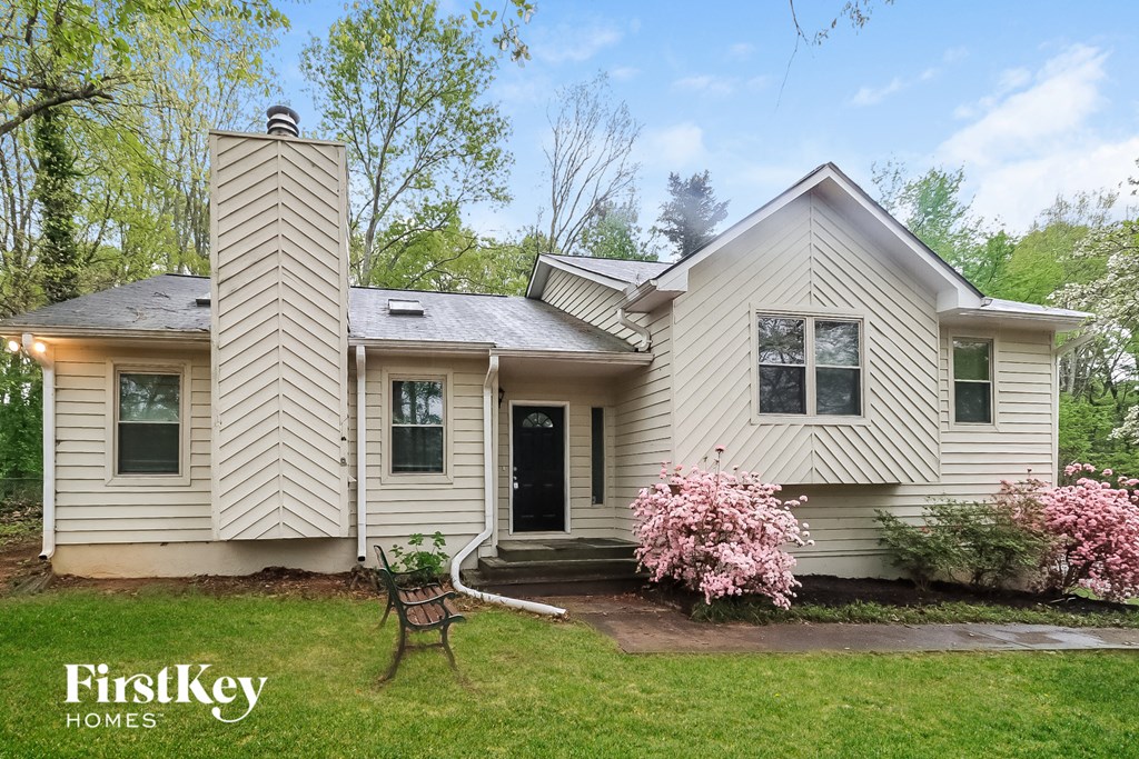A house with a white exterior and a black door is shown with the words "FirstKey Homes" on the bottom left.