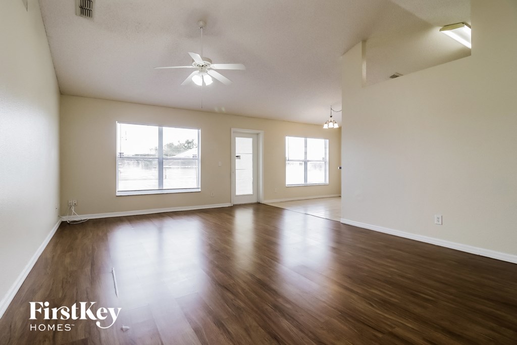the living room and dining room of an empty house