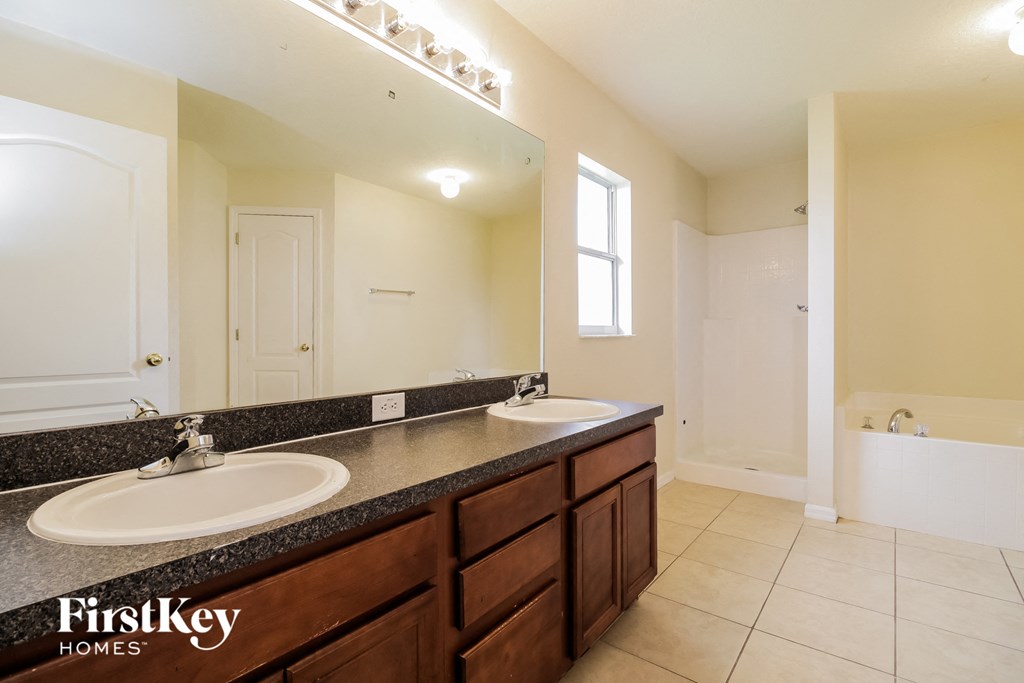 a bathroom with two sinks and a large mirror