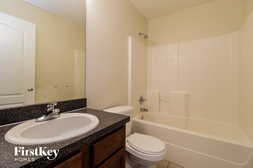 the interior of a bathroom with a sink toilet and tub