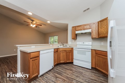 A kitchen with wooden cabinets and a white dishwasher.