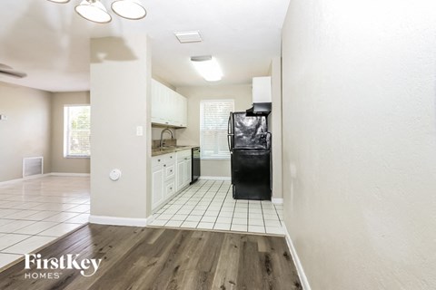 A kitchen with a dishwasher and a refrigerator.
