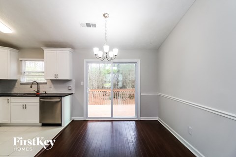 an empty living room with a sliding glass door to a patio