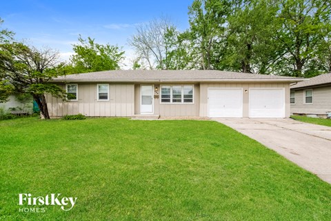 A house with a lawn in front of it.