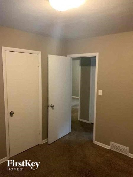 A room with a white door and a white door with a window.