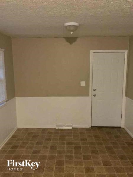 A room with a door and a tiled floor.