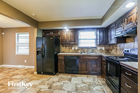 a kitchen with black appliances and wooden cabinets