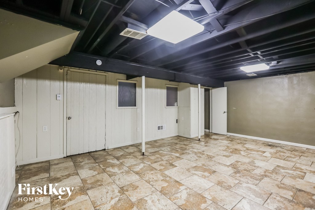 a large room with white cabinets and a tile floor