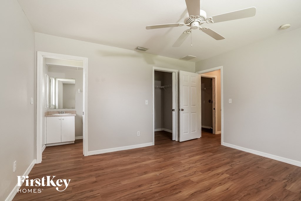 a living room with wood flooring and a ceiling fan