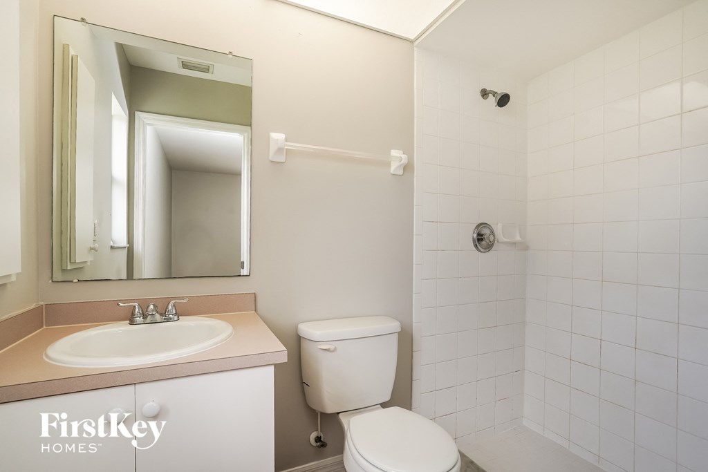 a bathroom with a sink toilet and a mirror