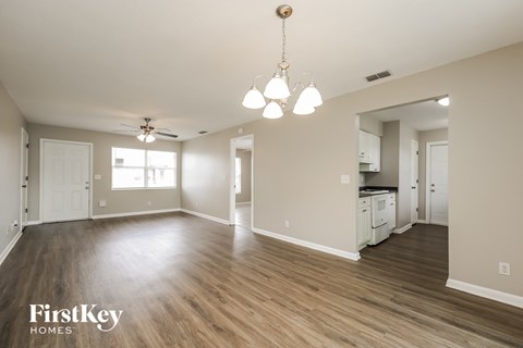 the living room and kitchen of an empty house