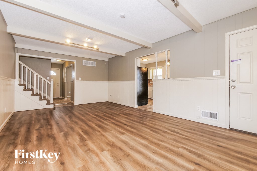 the living room is open to the dining room and kitchen