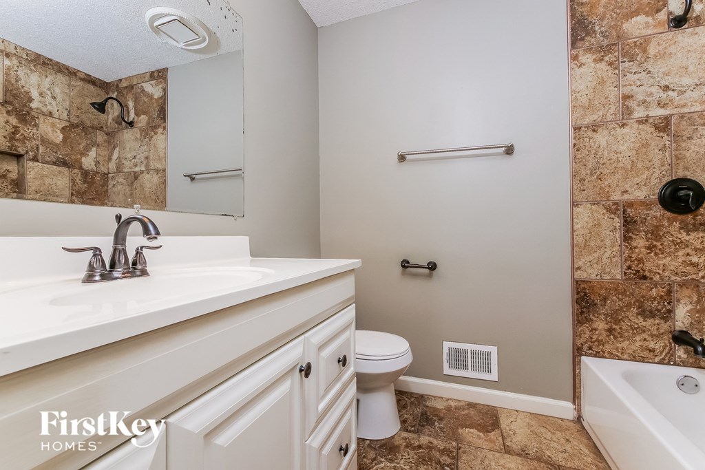 a bathroom with a sink and a toilet and a mirror