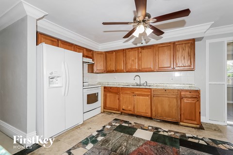 a kitchen with white appliances and wooden cabinets