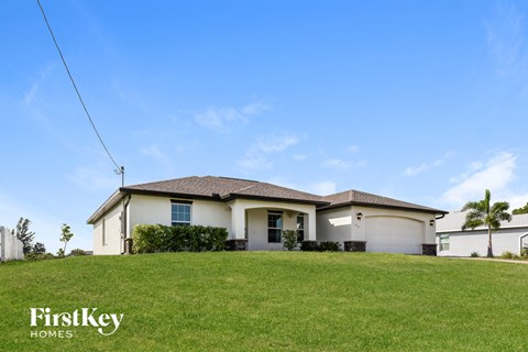 a house on a hill with a green lawn