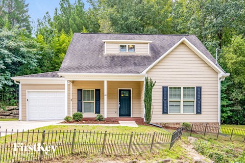 A house with a black fence in front of it.